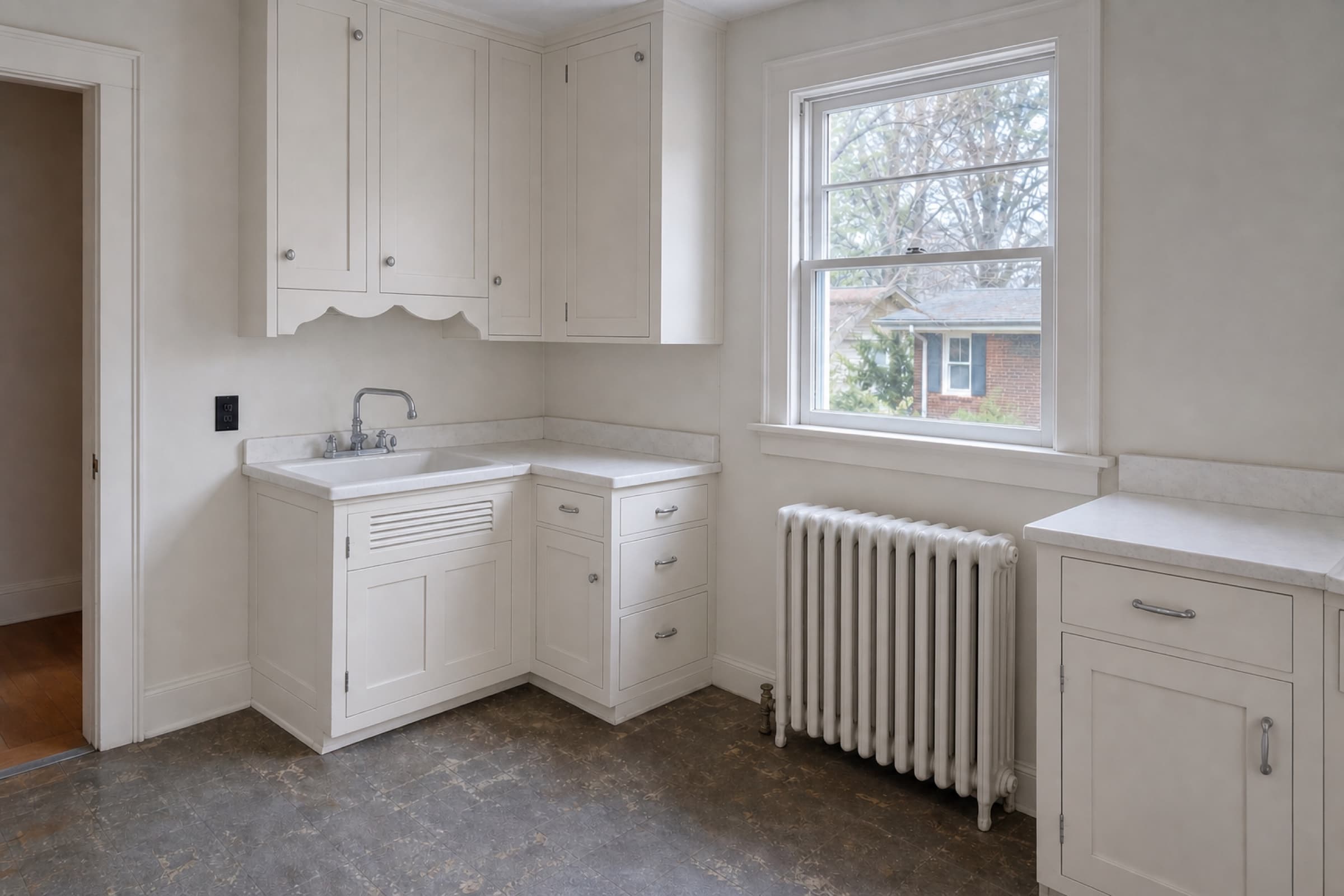 The same kitchen with inset painted face-frame cabinetry scribed to the plaster walls and a restored window